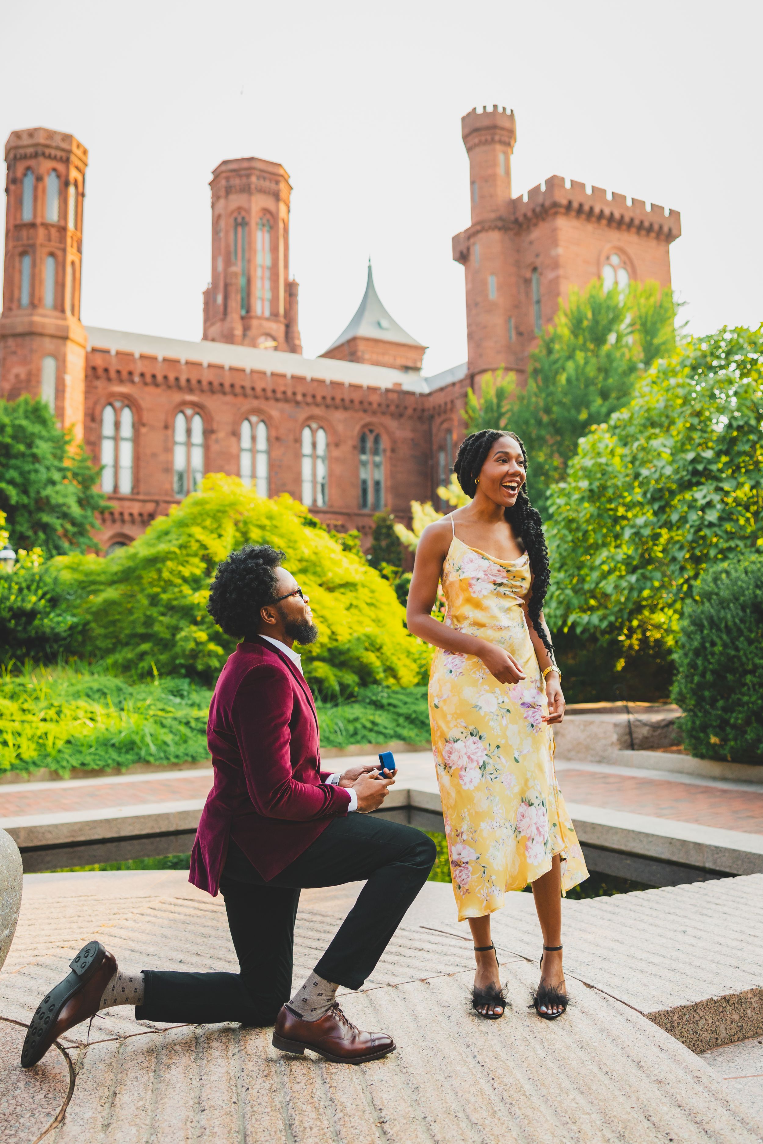 A couple shares a joyful moment during their engagement photoshoot at the Smithsonian Castle in Washington DC.