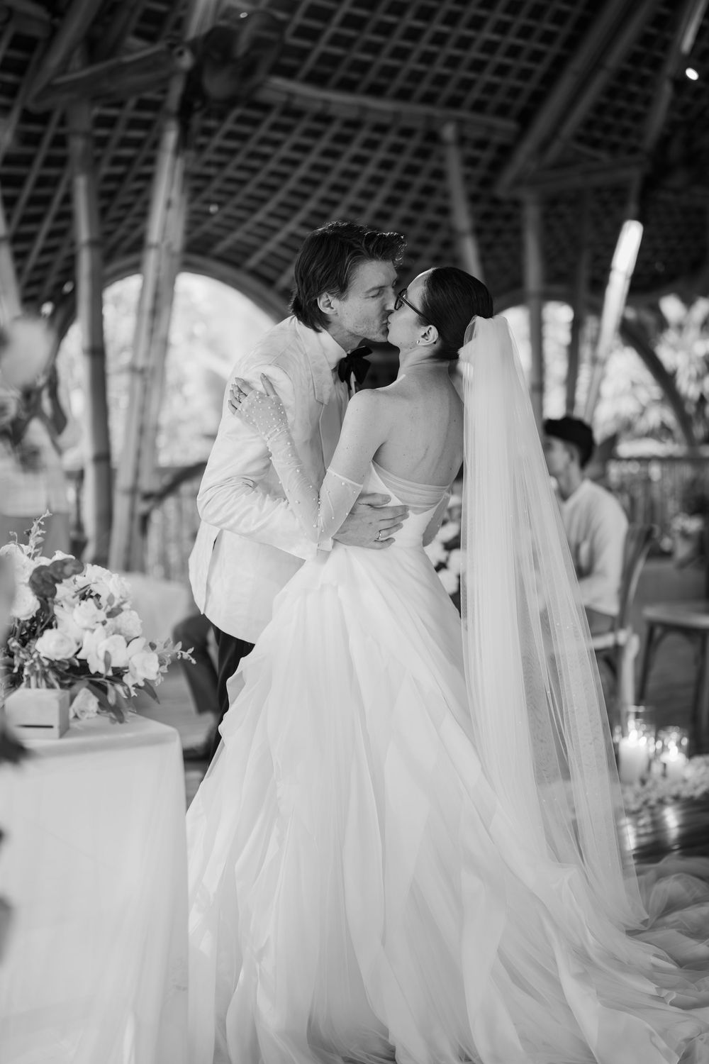 Black and white photos of wedding ceremony moments under an outdoor pavilion.
