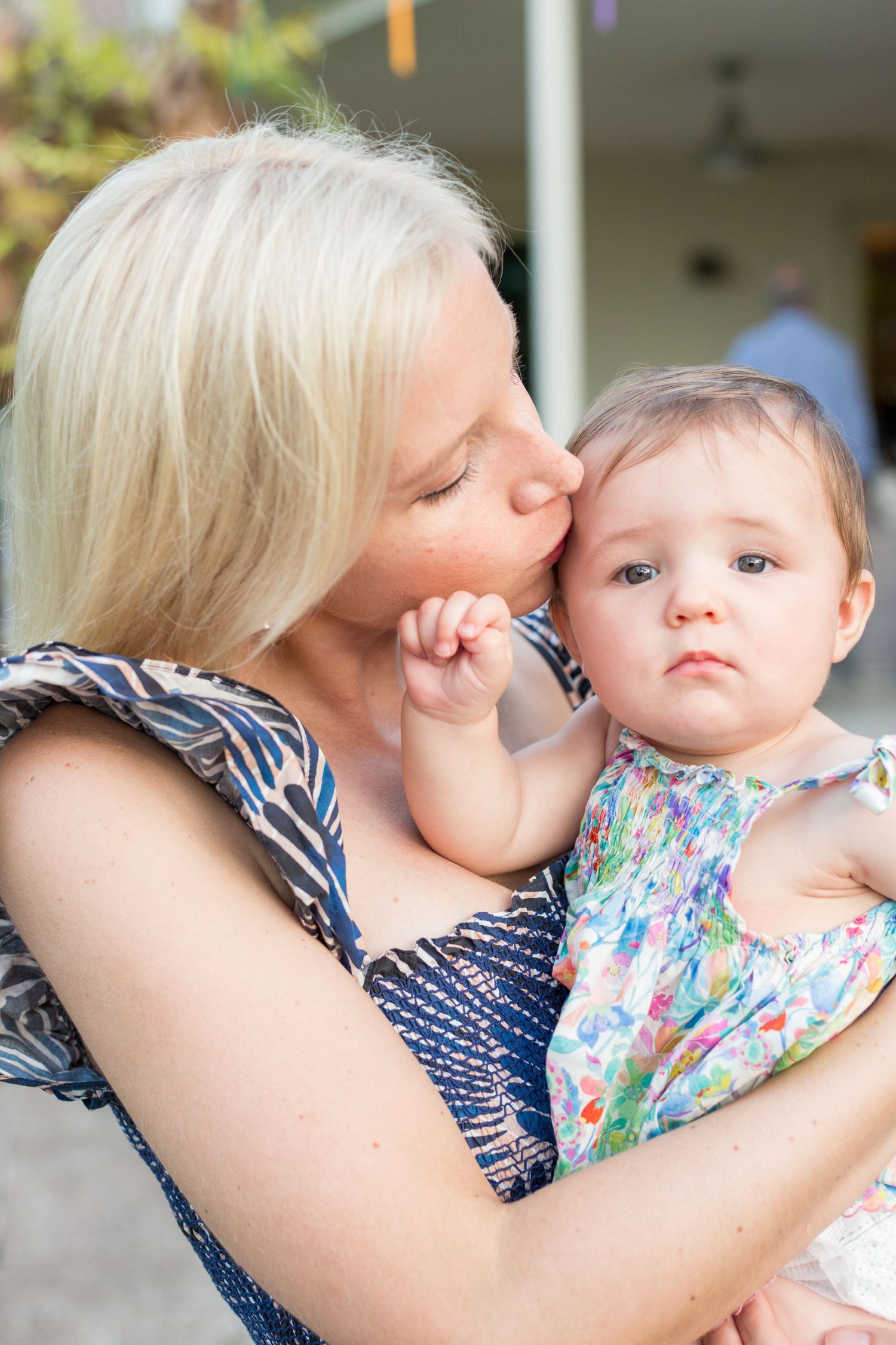 Mother kissing daughter. Kids birthday party in Guaynabo, Puerto Rico.