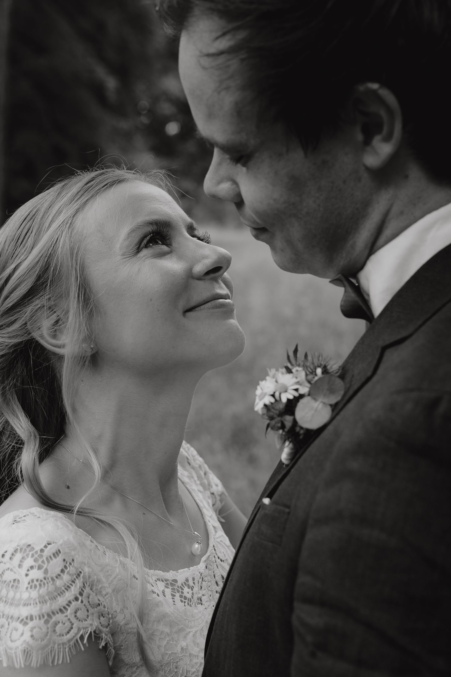 Black and white close-up portraits showing tender moments between newlyweds.