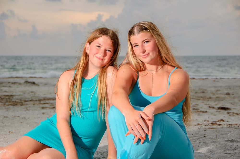 photo of sisters sitting in sand in New Port Richey
