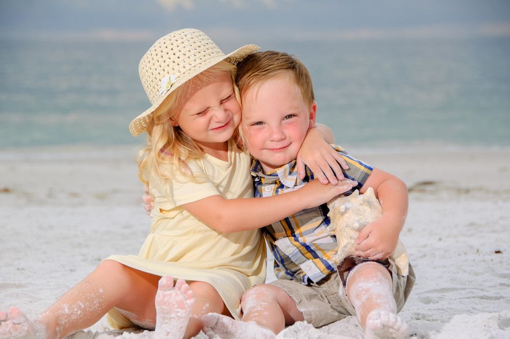 photo of young brother and sister hugging on New Port Richey beach
