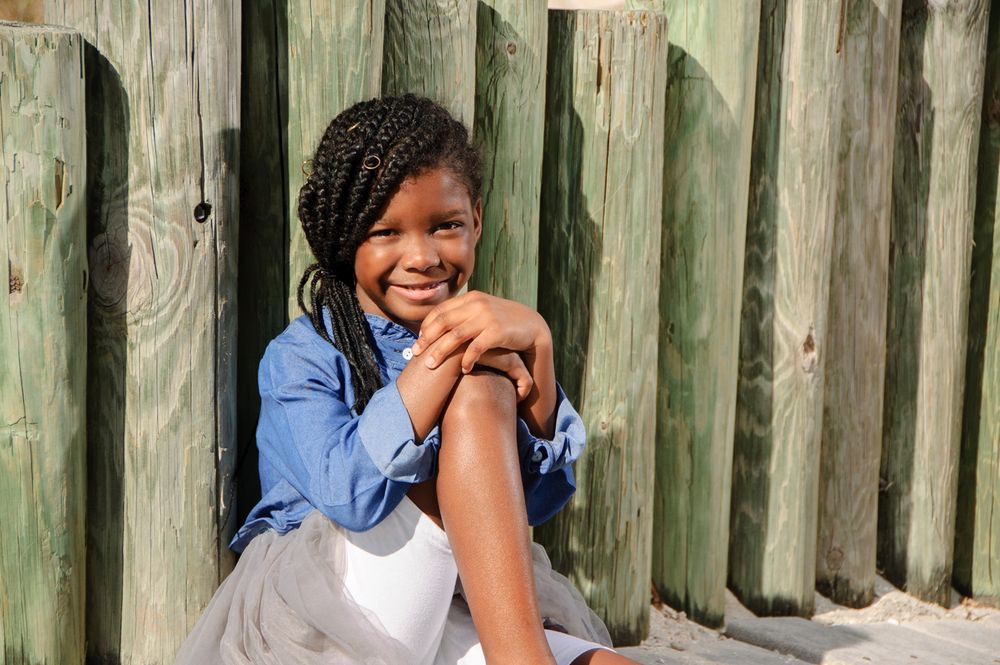 photo of pretty girl sitting on boardwalk in New Port Richey