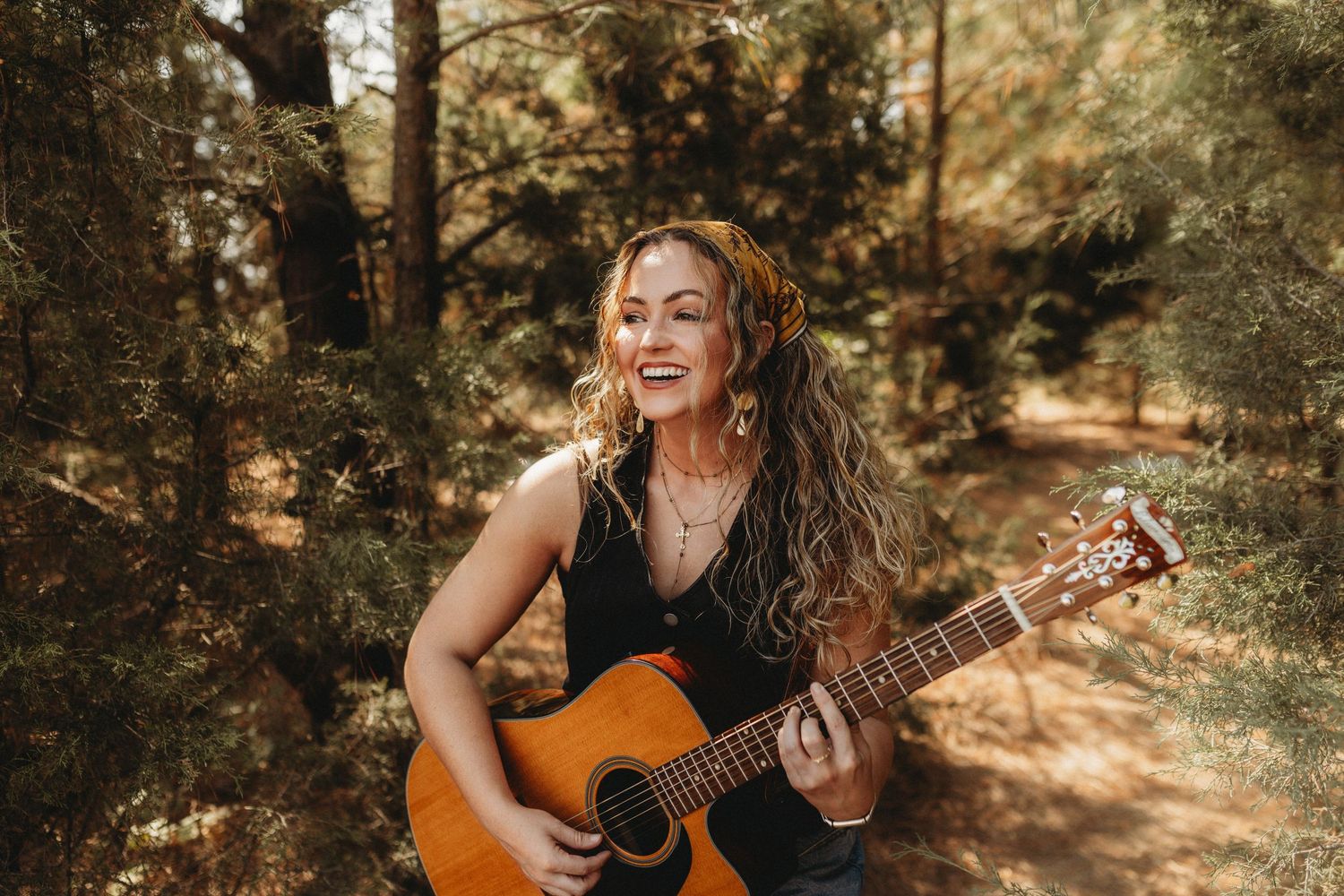 Senior with guitar in forest