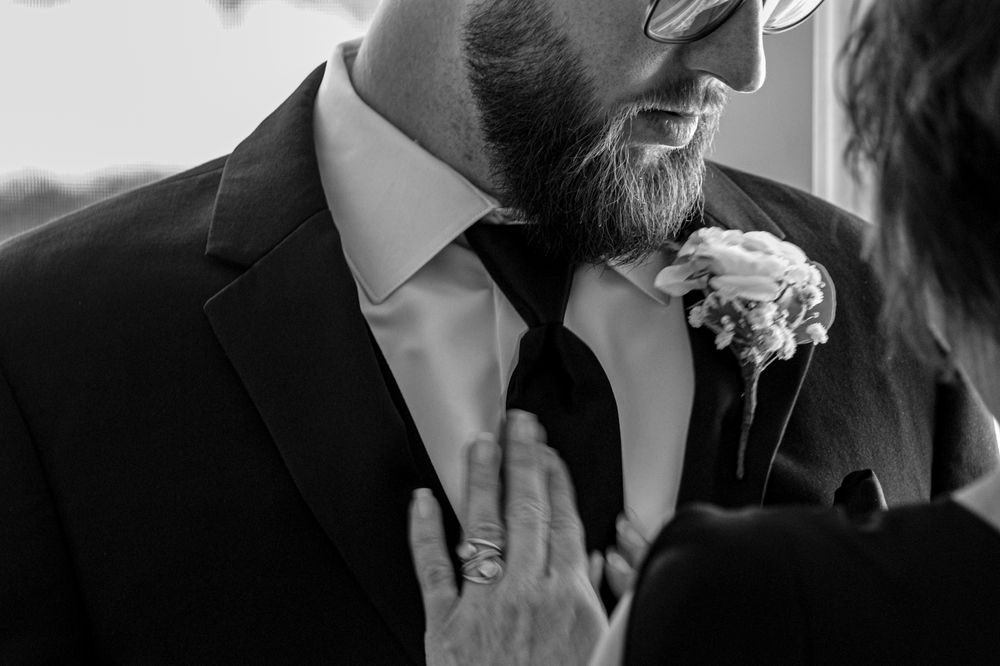 Black and white detail shots of formal wedding attire and accessories.