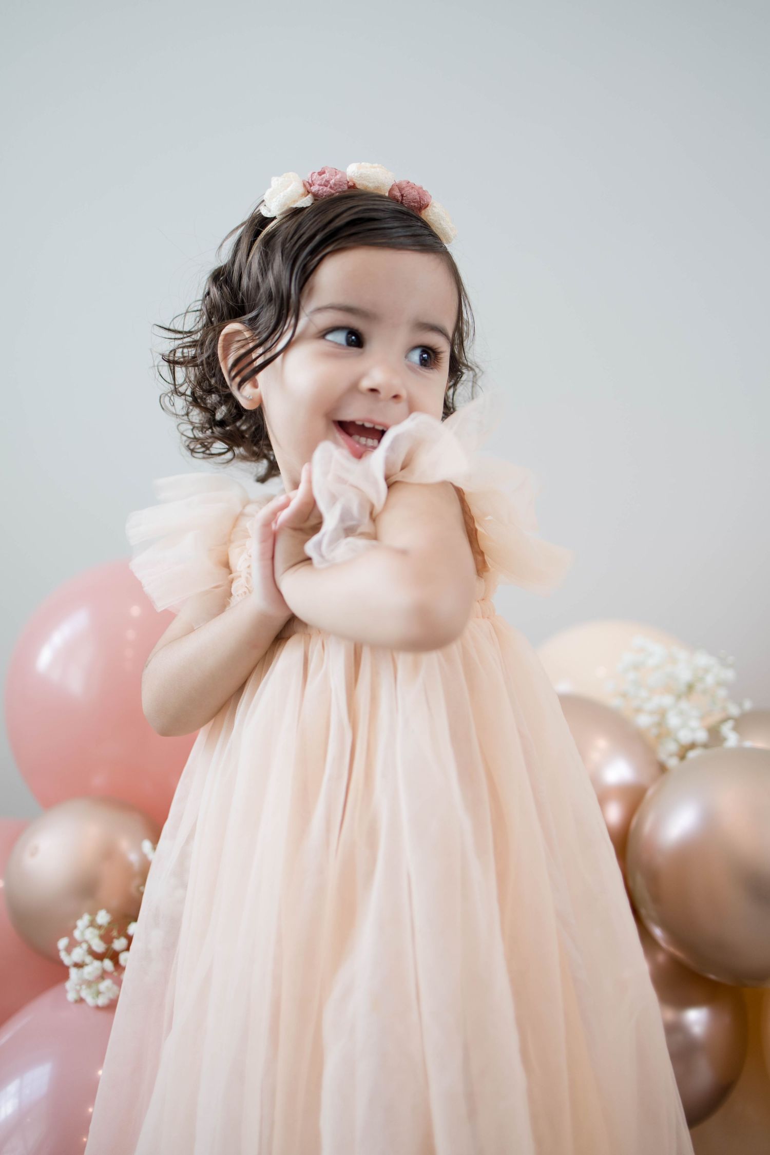 Smiling toddler capturing a special milestone moment during an indoor photography session in Cary, North Carolina
