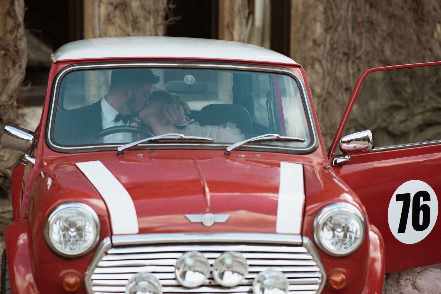 bride and groom in a mini cooper in England