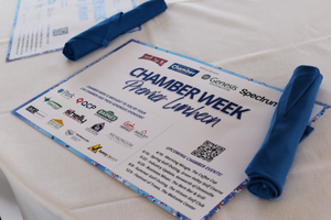A Chamber Week event flyer or program document with blue banner details lying on a white surface.