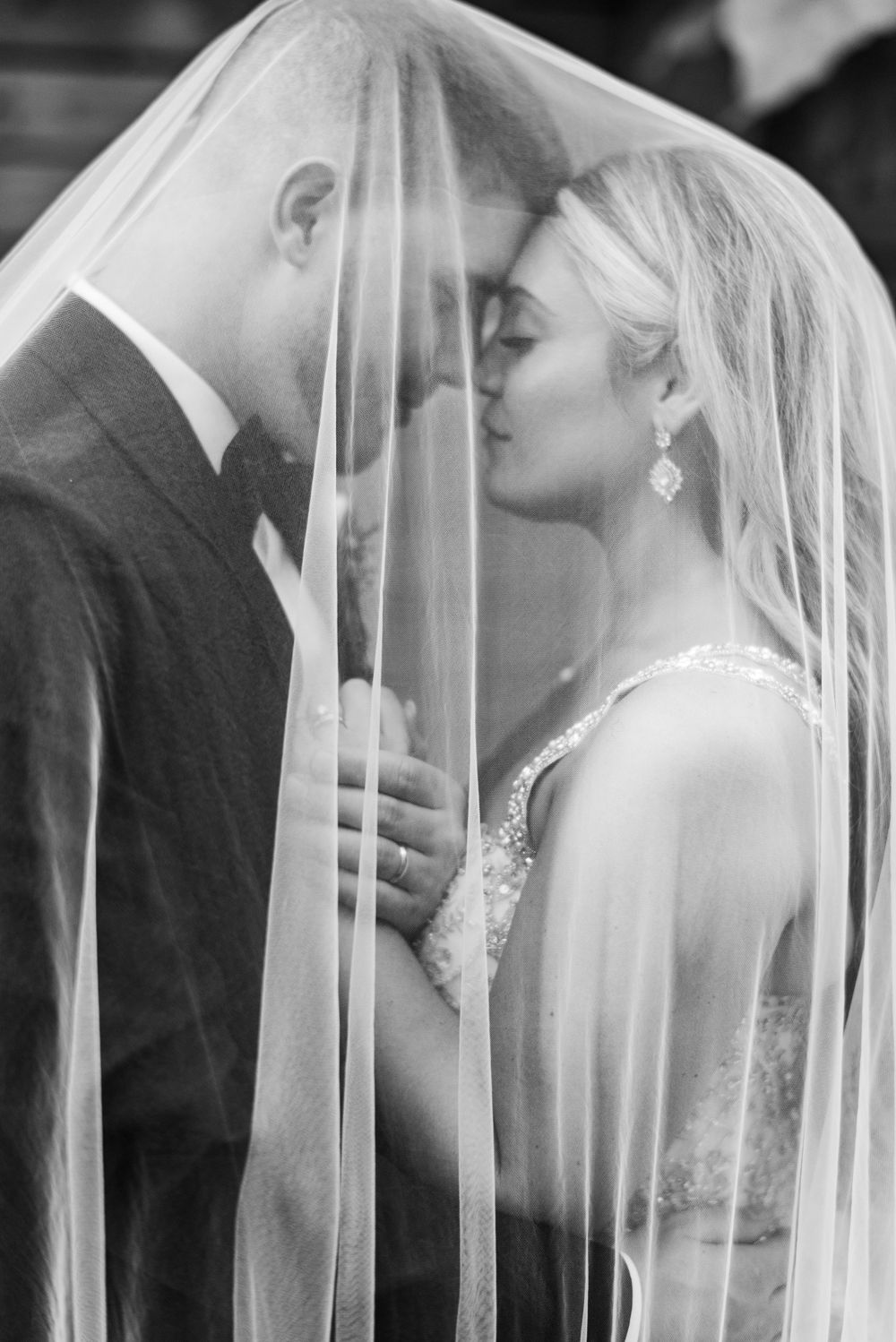 A series of romantic wedding portraits showing a couple through a delicate veil.