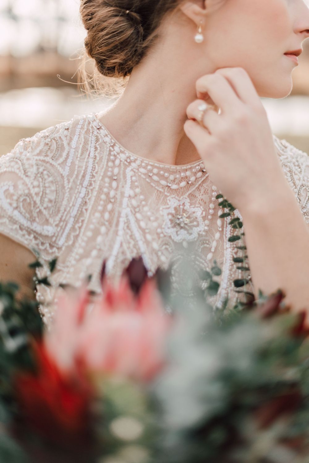 Close-up of intricate beaded wedding dress details with floral bouquet at jorgensen oak grove new albany ohio