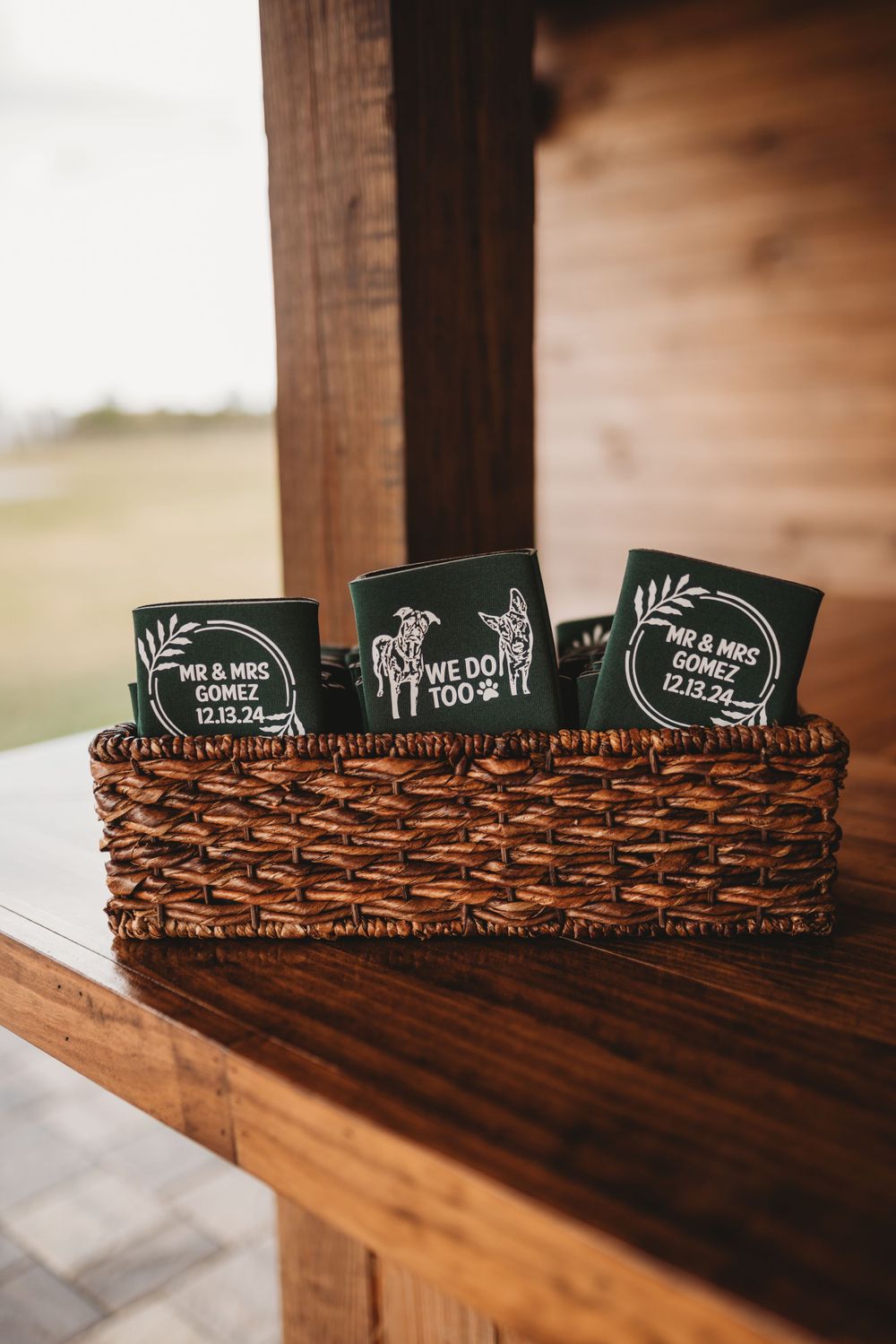 Black wedding fans arranged in a woven basket on a wooden ledge.