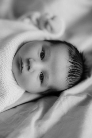 Newborn looking at camera captured by newborn Maryland photographer Mallory Bramlett.