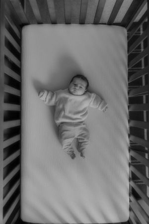 Newborn in crib captured by newborn Maryland photographer Mallory Bramlett.