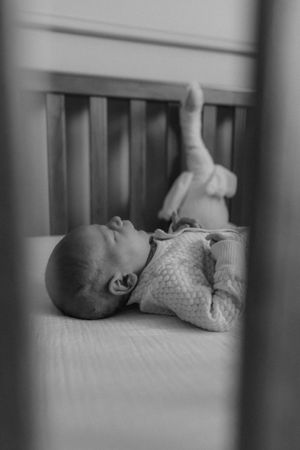 Newborn in crib for in home newborn session captured by newborn Maryland photographer Mallory Bramlett.