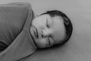A series of black and white photographs showing someone sleeping peacefully on what appears to be a couch or bed.