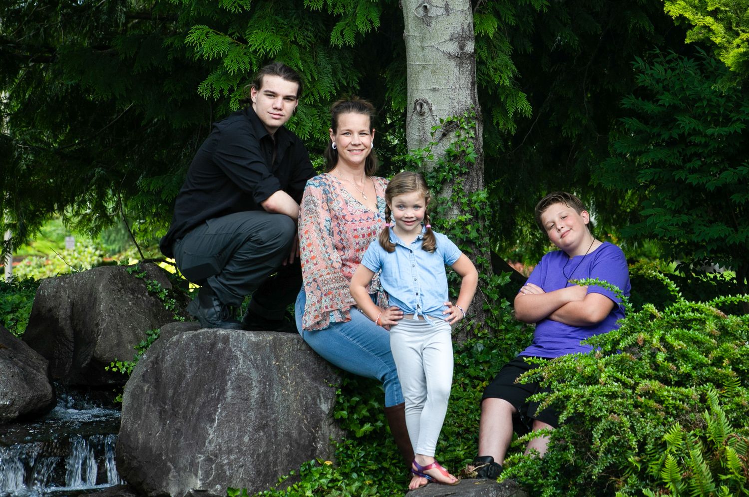Family of 4, Mom with three kids posing on boulders