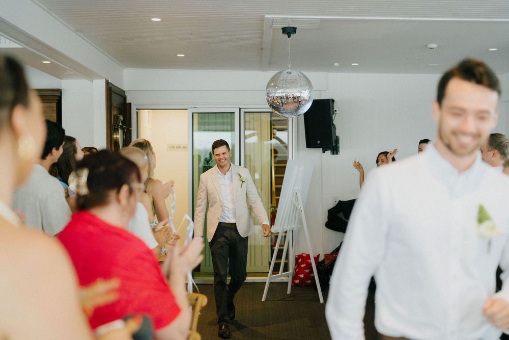 Fun-filled wedding reception at Noosa Boathouse, capturing laughter and celebration in a candid style.”