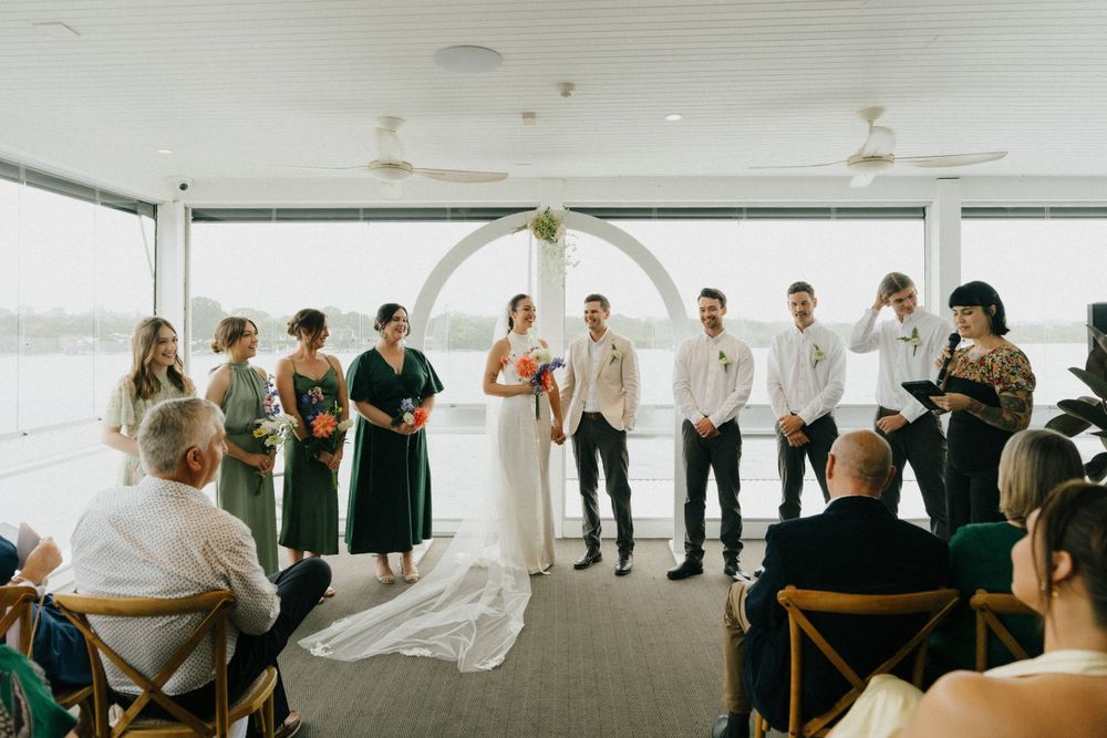 4.	“Rainy wedding ceremony at Noosa Boathouse with a cozy atmosphere, captured by a documentary wedding photographer.”