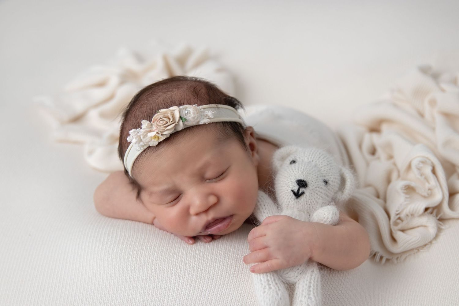 Close-up of baby girl swaddled during San Diego newborn session at home