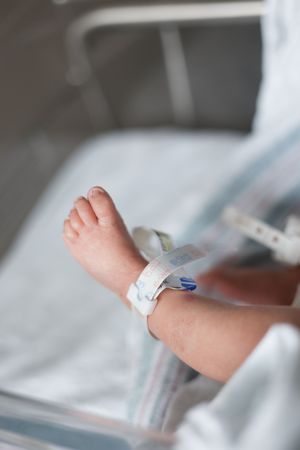 Close-up sequence showing medical equipment and bandages being applied to a patient's arm in a hospital setting.