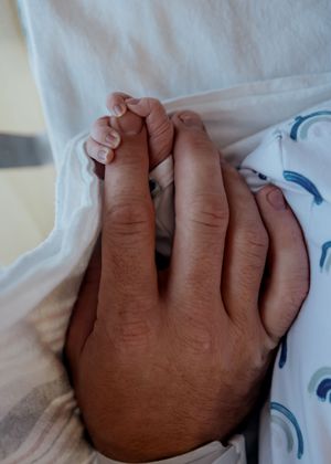 A sequence of images showing a hand resting on white bedding with blue pattern details.