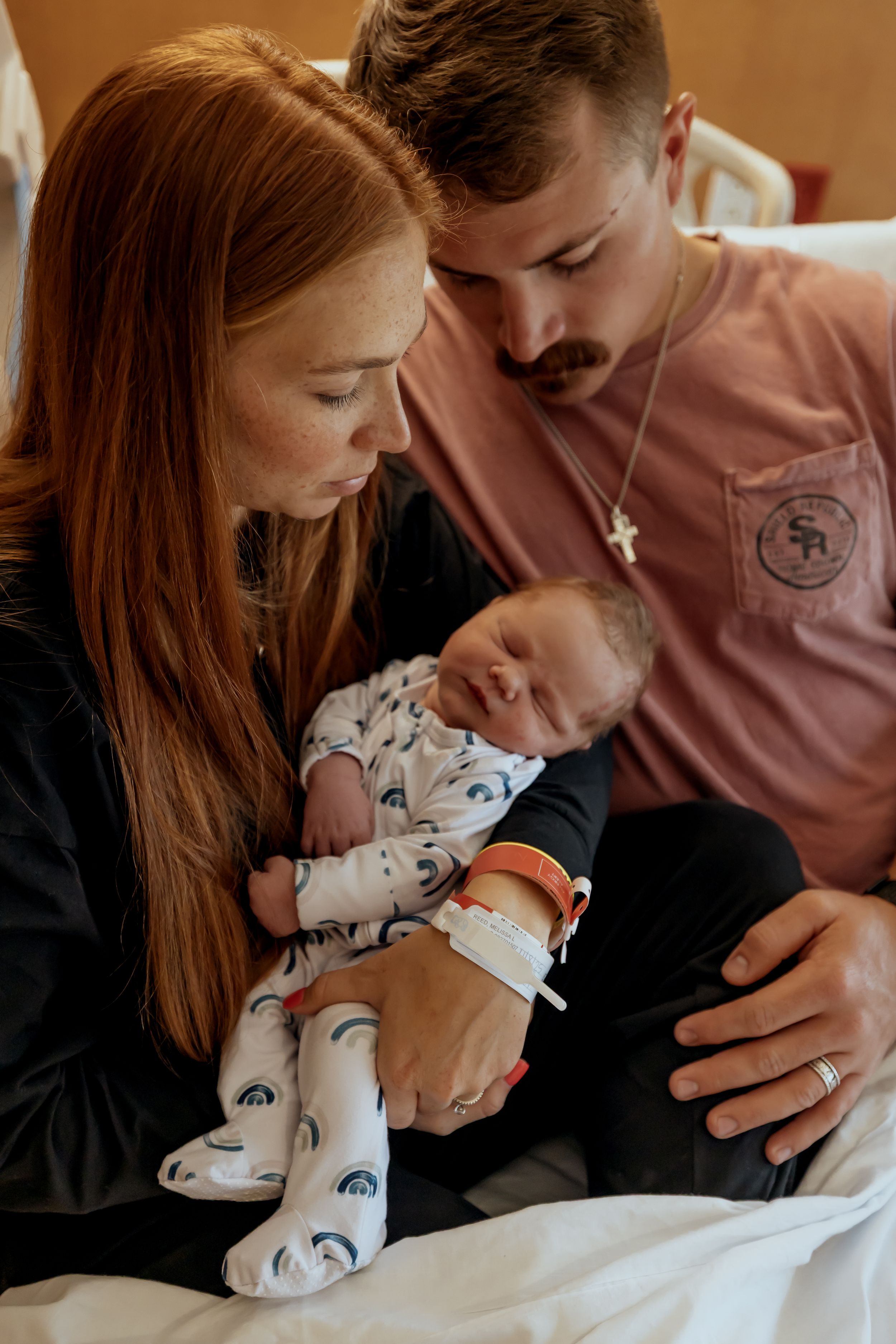 Parents lovingly comfort their newborn baby in a tender series of intimate hospital moments after birth.