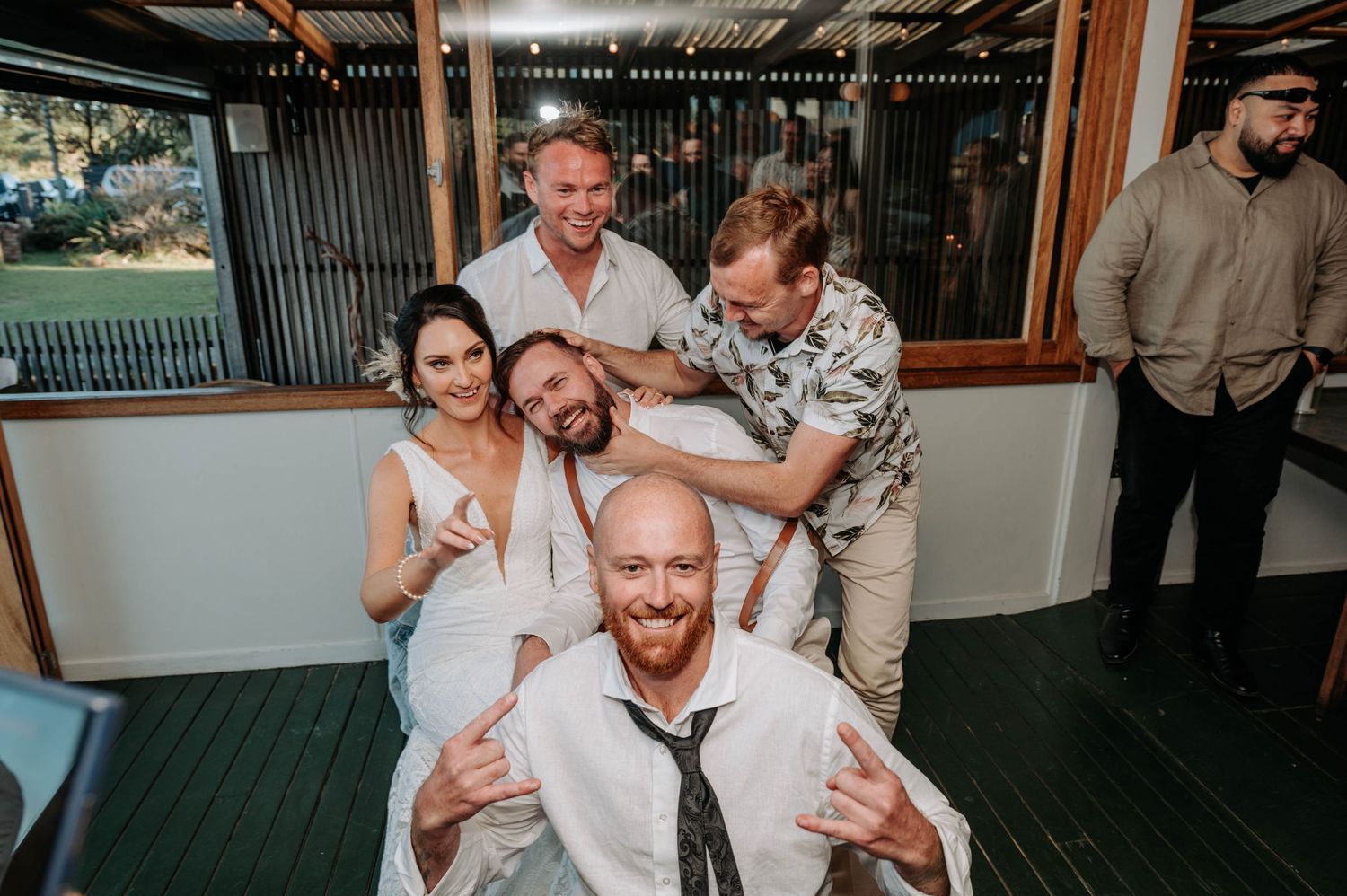 Candid group photo of wedding party having fun and laughing together.