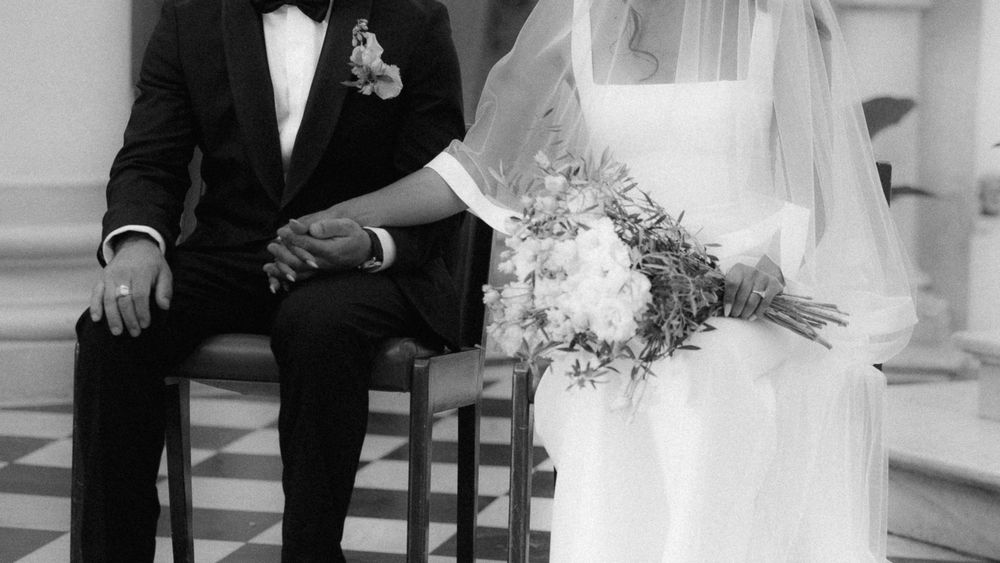 Formal wedding ceremony taking place in traditional church setting.