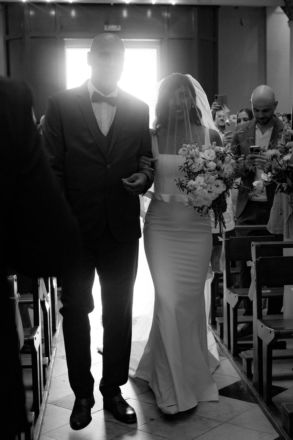 Wedding ceremony in a church with black and white checkerboard floor.
