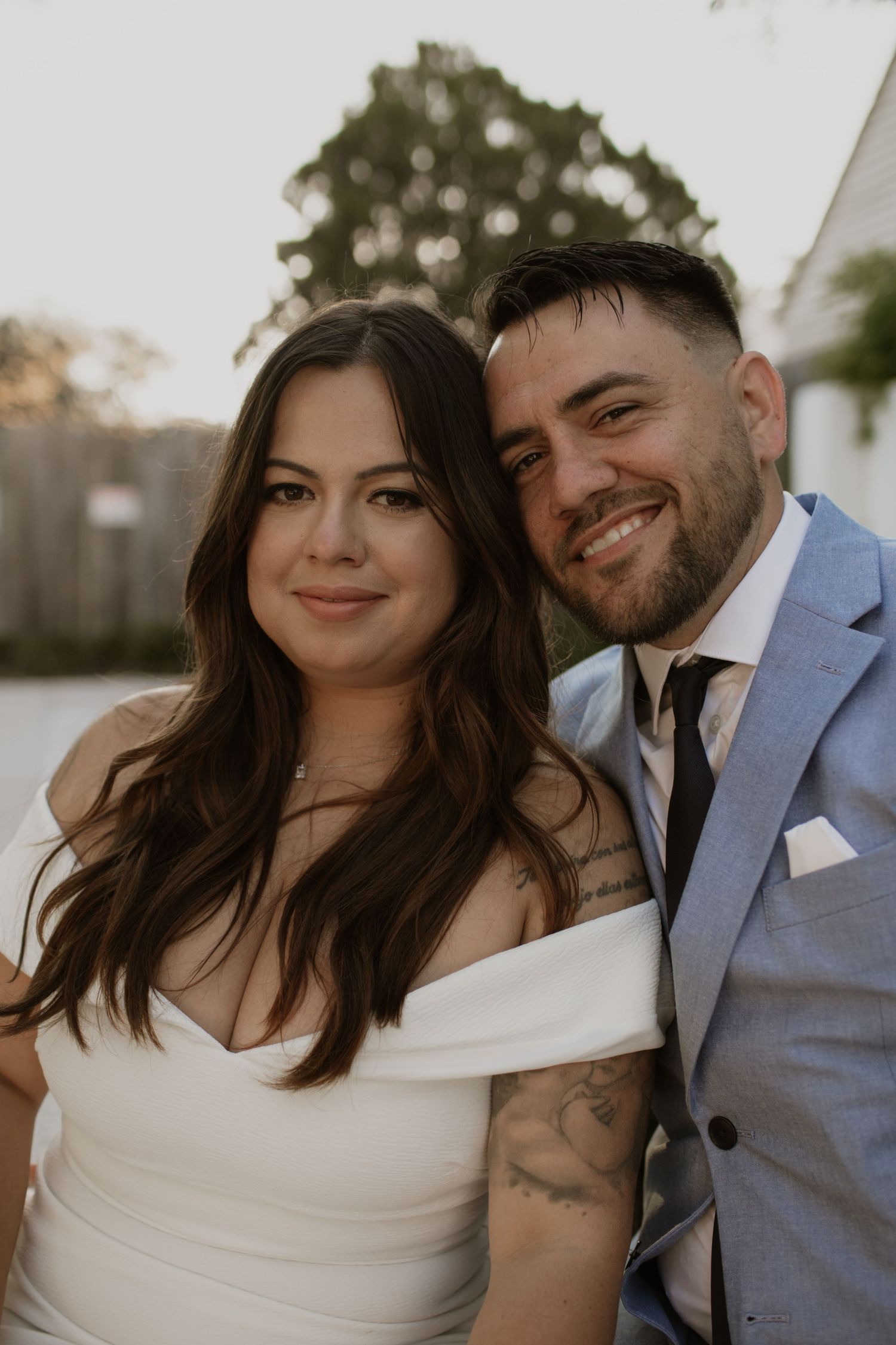 Couple in formal attire poses for romantic waterfront portraits.