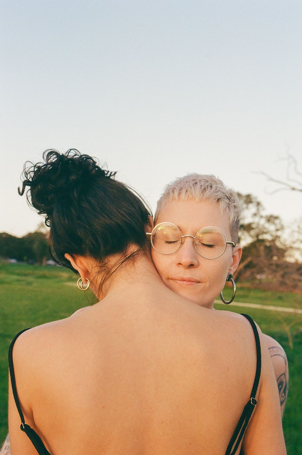 Intimate LGBTQ+ couple portrait in nature, celebrating one year together, Perth queer-friendly photographer.