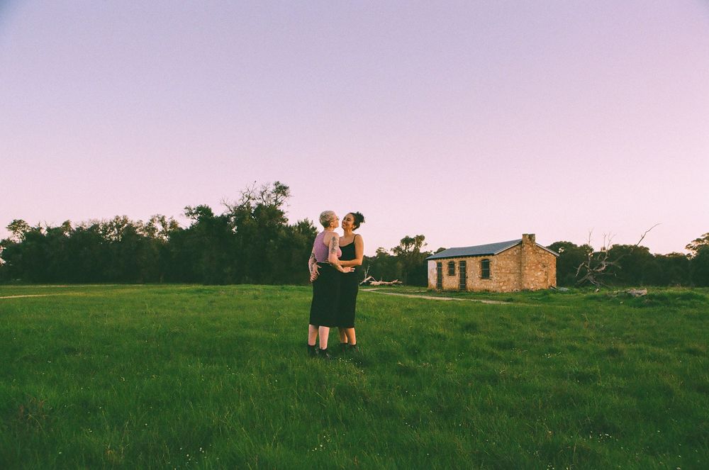 Intimate LGBTQ+ couple portrait in nature, celebrating one year together, Perth queer-friendly photographer.