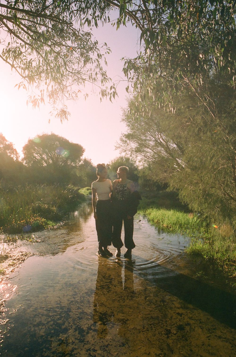 Queer love anniversary shoot in Perth, Sarah and Viviane photographed outdoors in golden light.