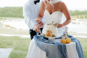 Close up of a white wedding dress with light blue details and decorative elements.