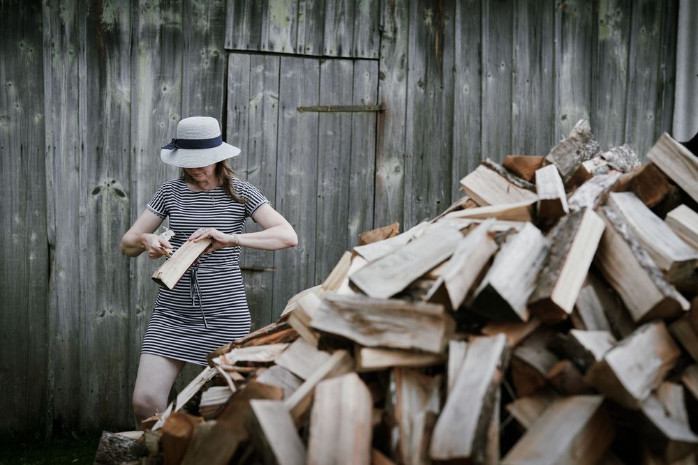 rustic photoshoot, firewood backdrop, countryside model, natural textures, autumn vibes, earthy tones, outdoor portrait