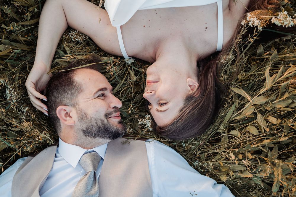 A collection of romantic wedding photos shows affectionate moments between a bride and groom outdoors in nature.