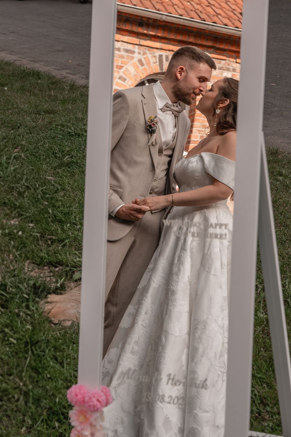 Wedding couple sharing an intimate moment on a white porch with a terra cotta roof in the background.