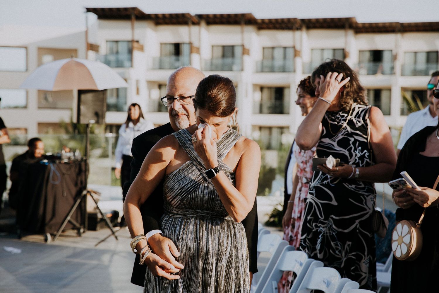 Emotional wedding ceremony reactions from guests at modern rooftop venue.