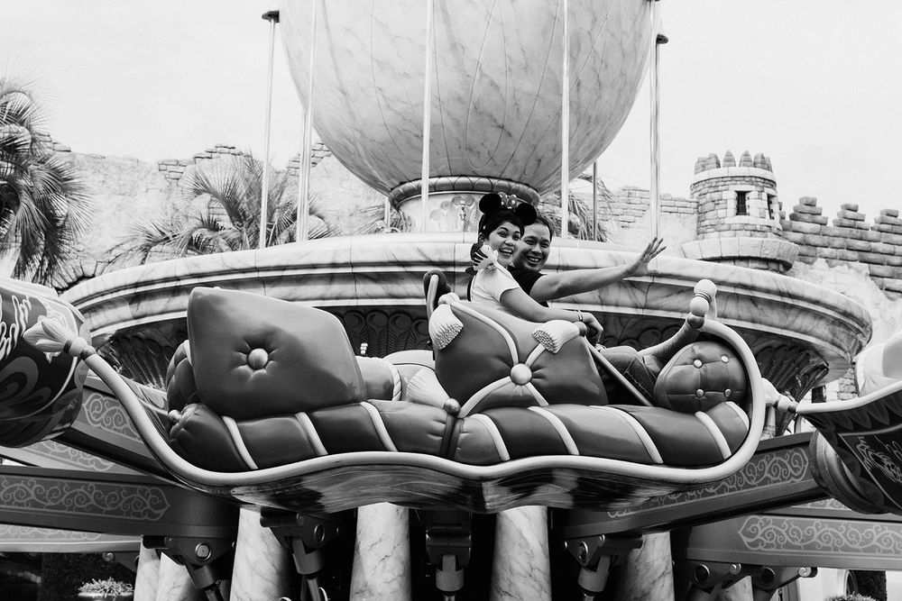 A black and white photograph of a vintage Dumbo ride at Disneyland showing an aerial view of the flying elephants.