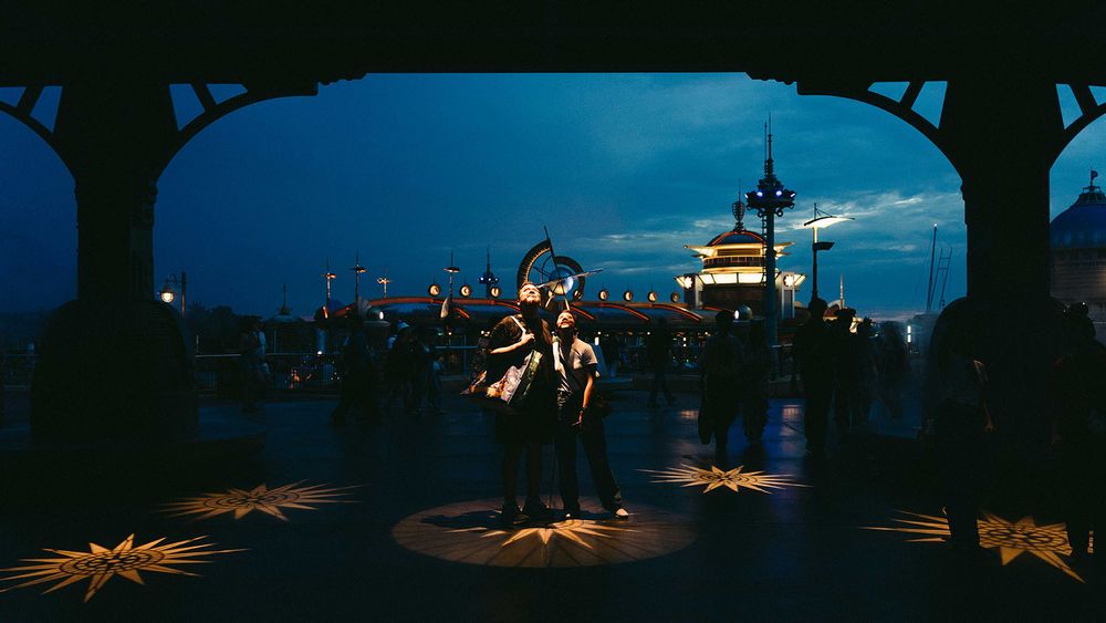Series of panoramic silhouettes against a dark blue twilight sky showing architectural elements and trees.