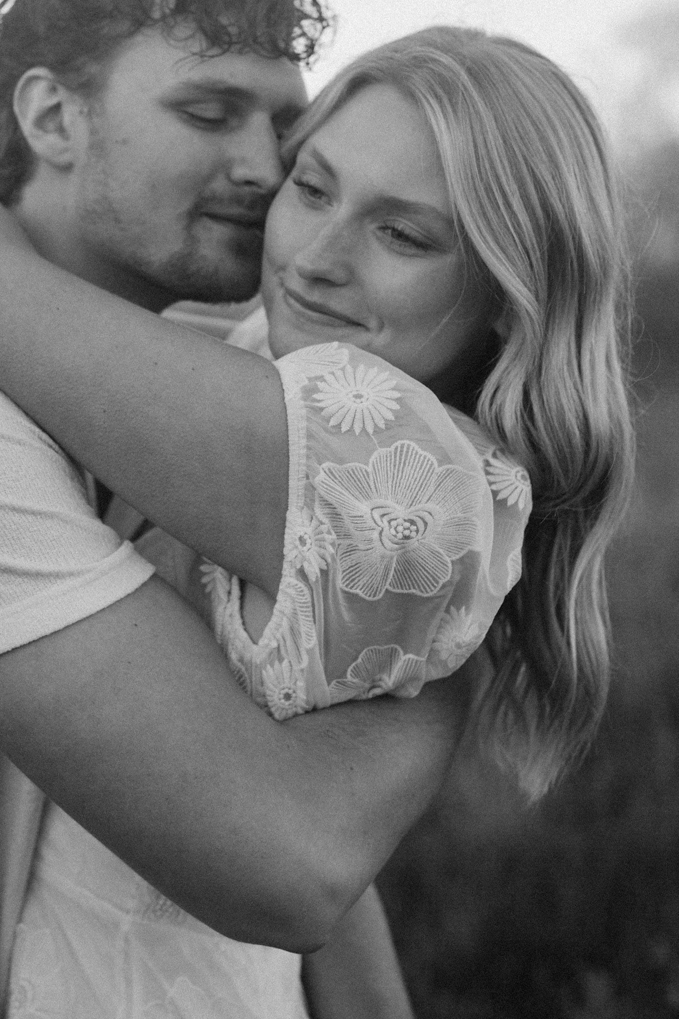 Couple embracing in black and white during Grand Rapids engagement session.