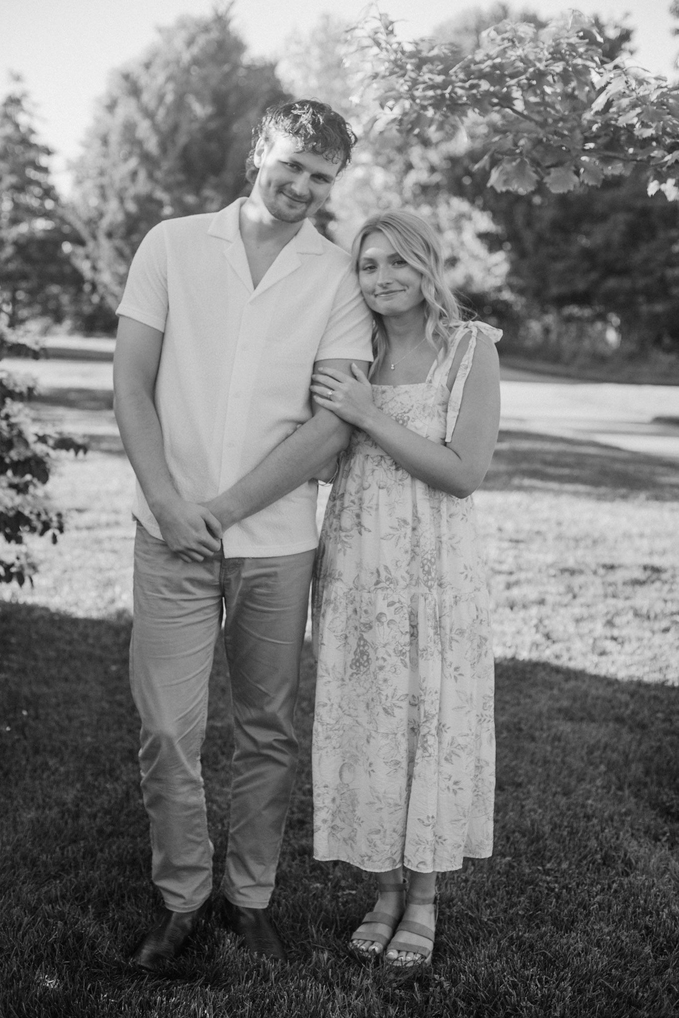 Couple standing next to each other during their engagement session at Millennium Park in Grand Rapids MI.
