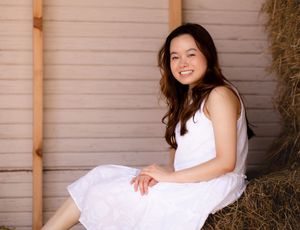 A rustic wooden wall creates a simple, natural backdrop for portraits.