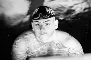 Black and white close-up shot of competitive swimmer in action.