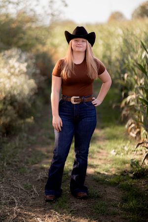 Country-style portraits in jeans and cowboy boots against a natural backdrop.