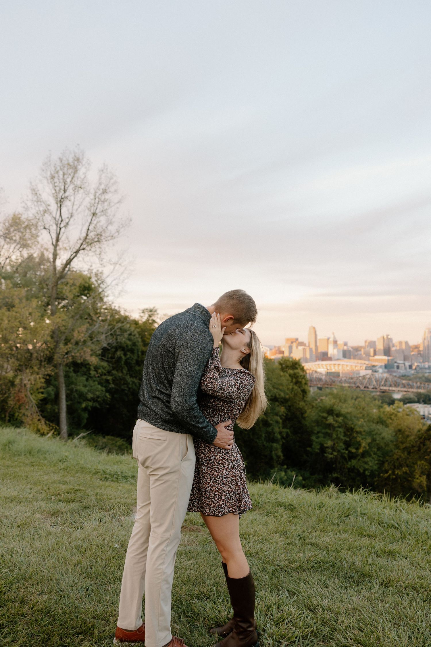 Intimate family moment captured on a rattan chair surrounded by romantic floral arrangements against neutral wall.