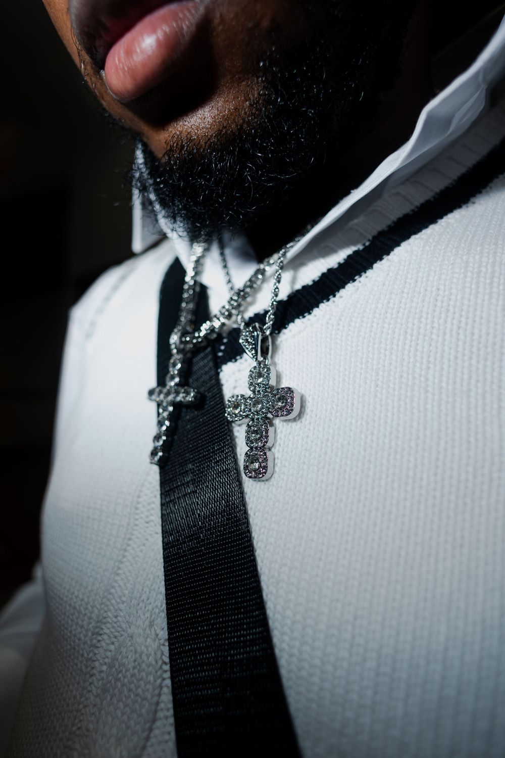 Extreme close-up of a black tie against a white textured fabric.