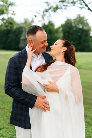 Three romantic images show a couple embracing in a green outdoor setting, with the bride wearing a flowing white veil.