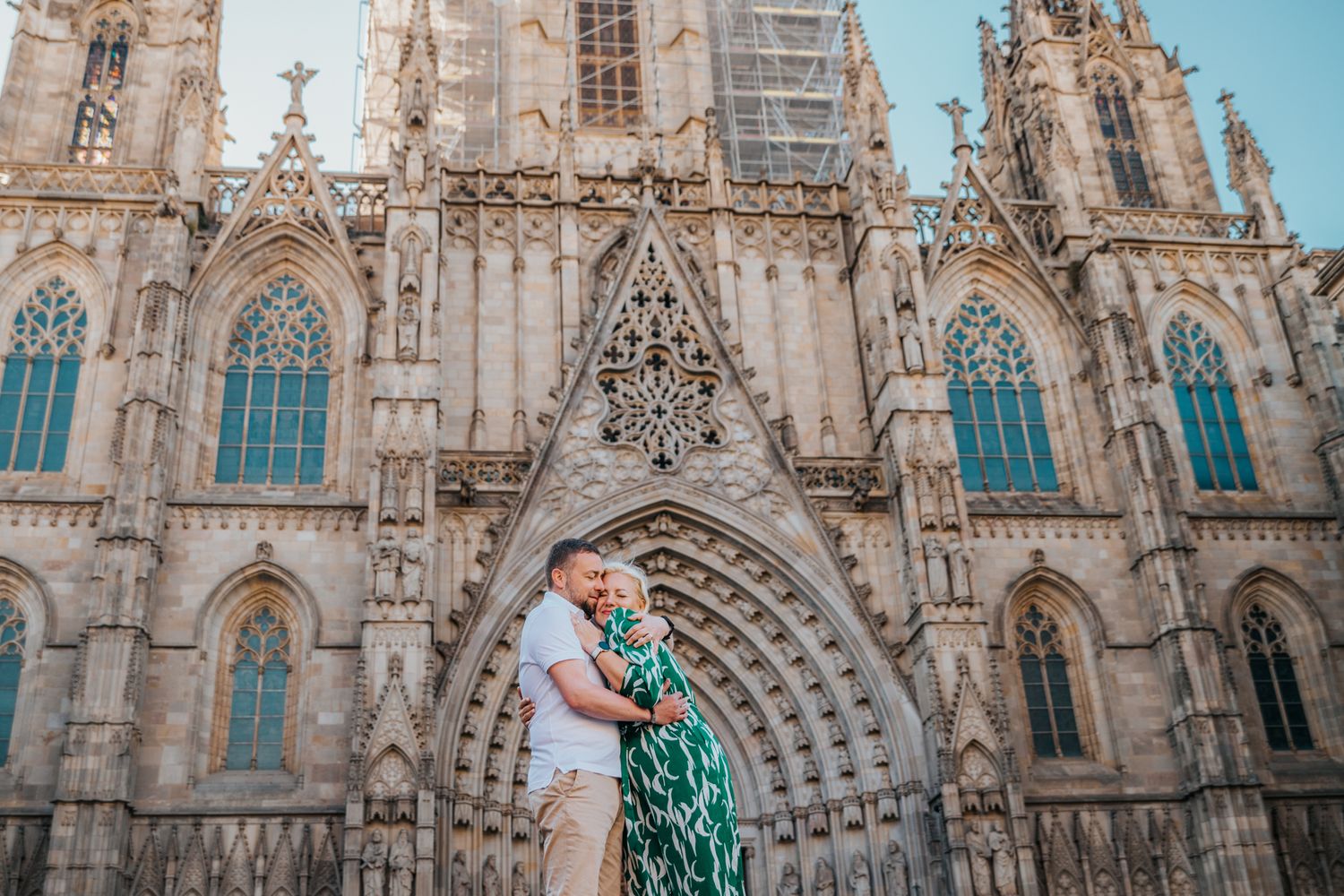 Anniversary couple walking hand-in-hand through narrow Barcelona alley