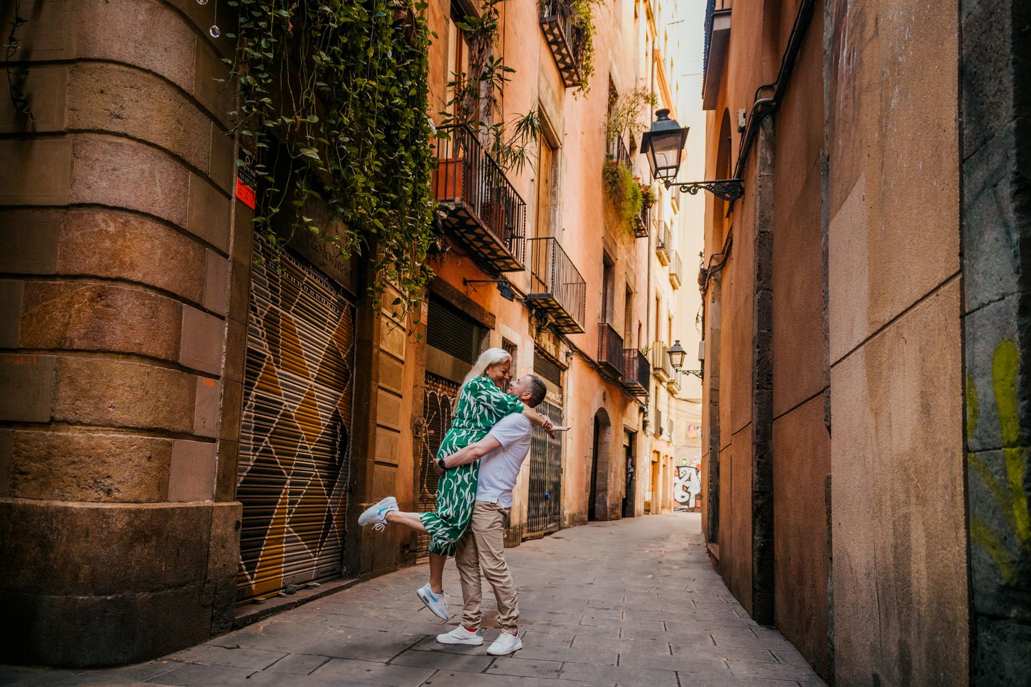 Couple looking at each other lovingly on cobblestone street